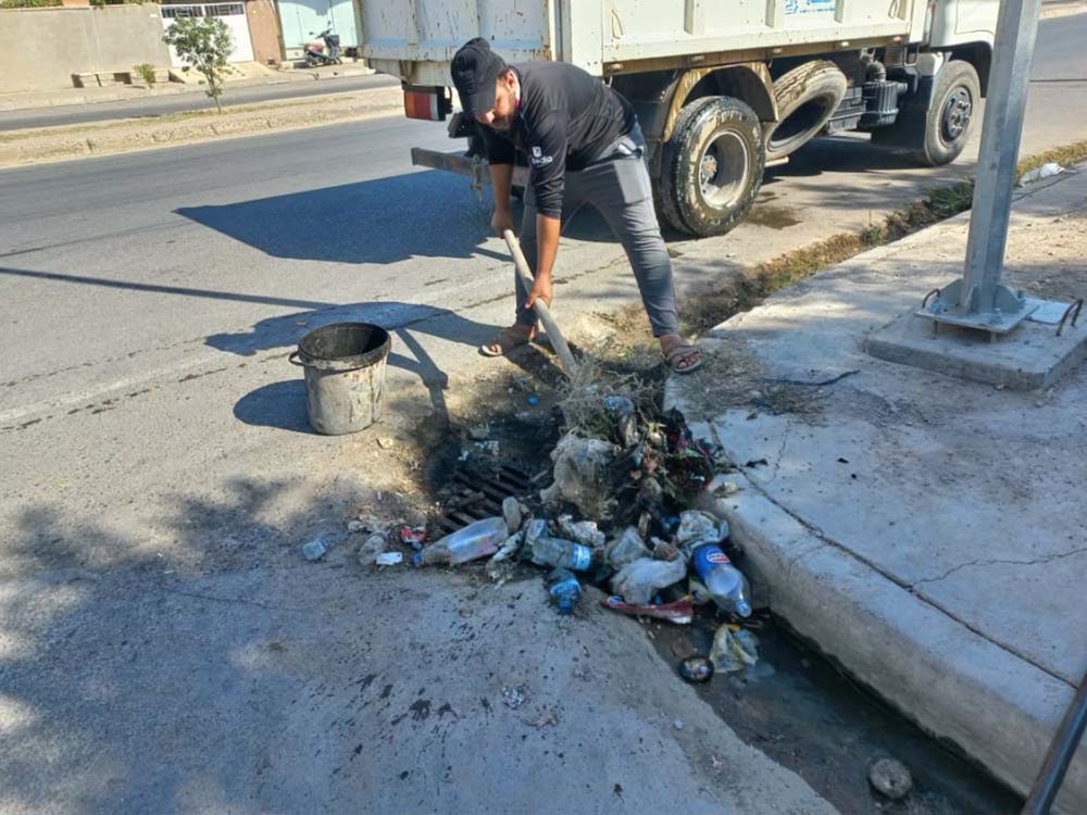 عامل ينفذ أعمال تنظيف وصيانة أحد منهولات شبكة المجاري ضمن حملة تأهيل شبكات الصرف الصحي في نينوى