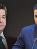 "صورة مركبة تجمع بين رئيس حكومة إقليم كردستان مسرور بارزاني (على اليسار) ببدلة سوداء وربطة عنق خضراء داكنة، والأمين العام لكتائب سيد الشهداء أبو آلاء الولائي (على اليمين) ببدلة كحلية وربطة عنق زرقاء ويتحدث أمام ميكروفون، على خلفية داكنة."
